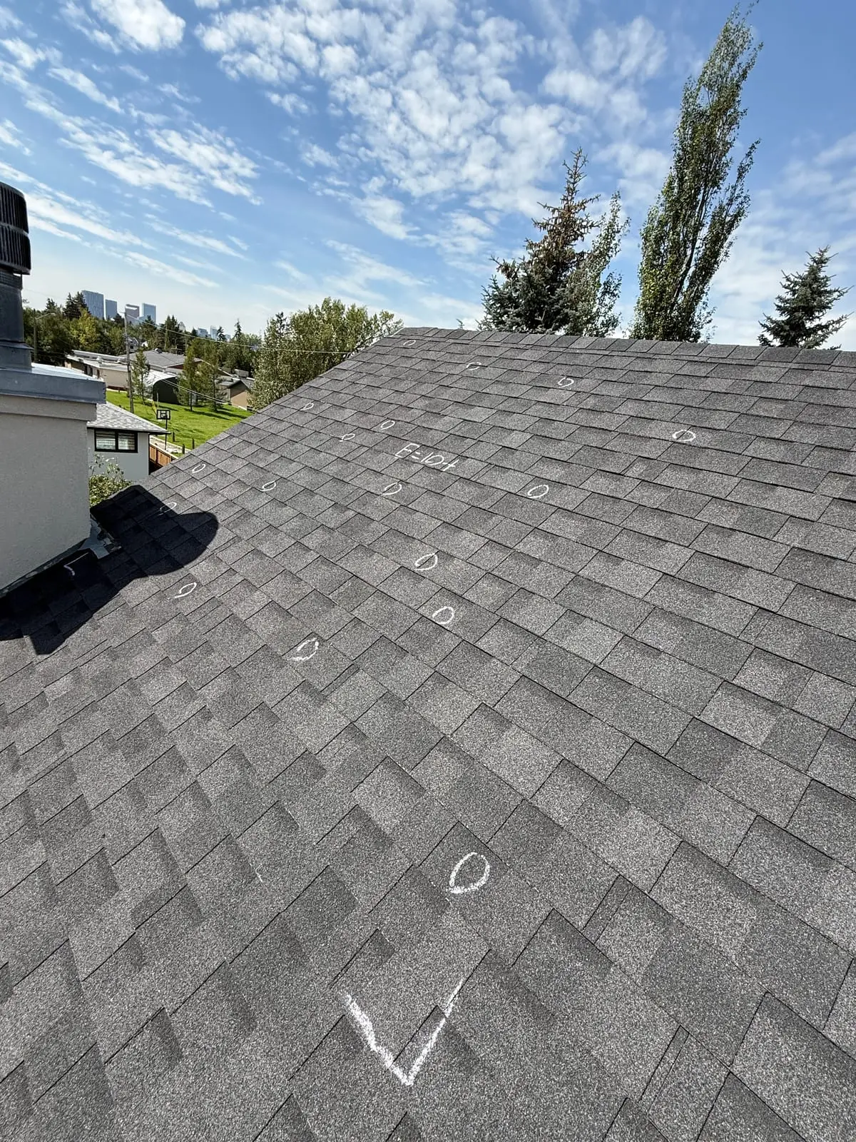 Chalk-marked hail damage documented on a Calgary roof during a HAAG-certified assessment