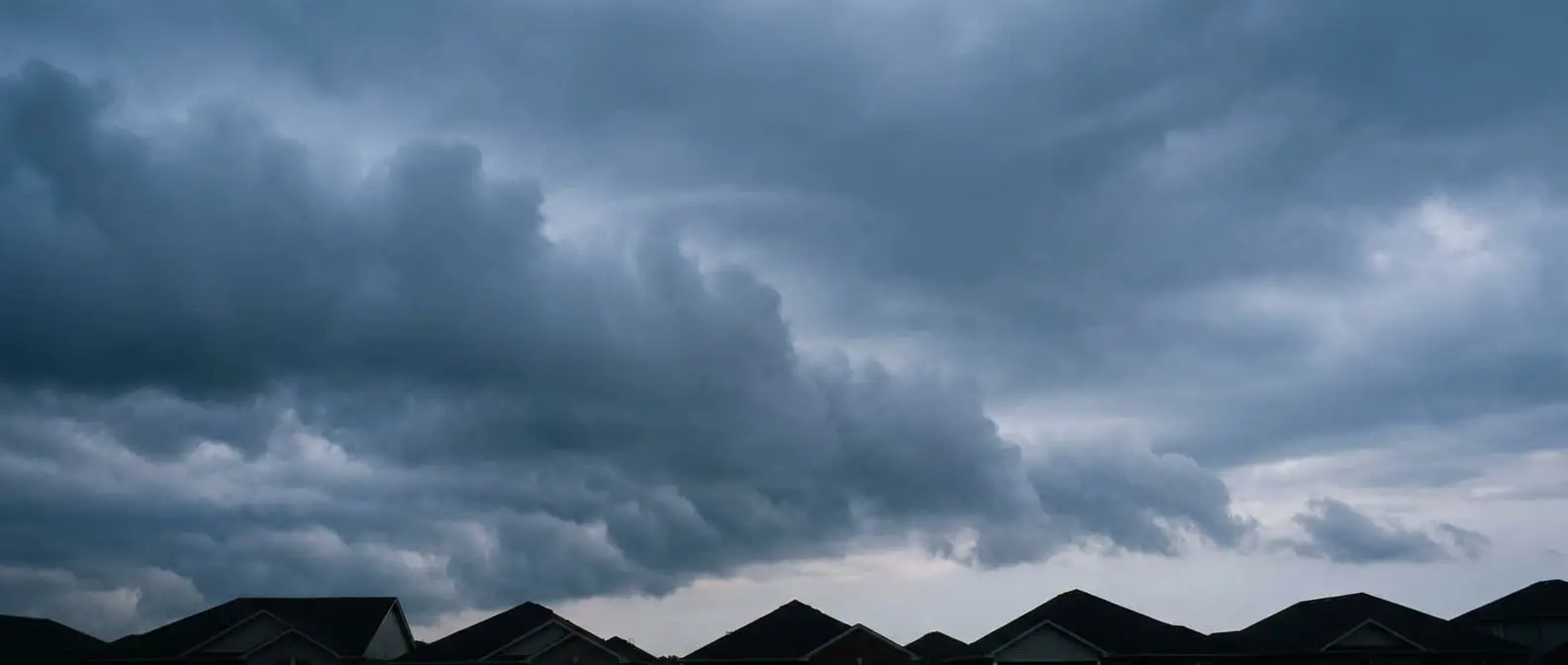 Storm clouds over suburban rooftops